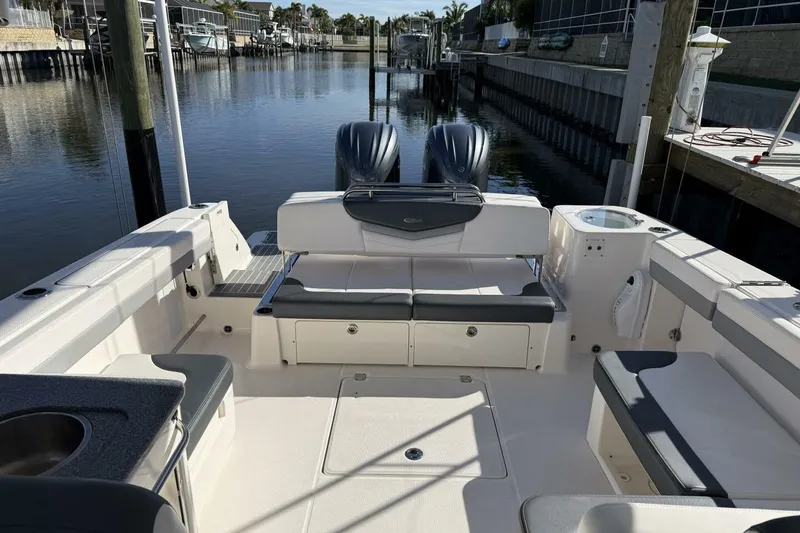 Slide: The Image of 2021 Robalo R317 Dual Console boat interior with seating and water view. - 19