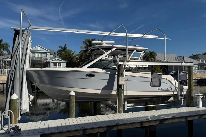 Slide: The Image of 2021 Robalo R317 Dual Console boat on lift at dockside, sunny day. - 26