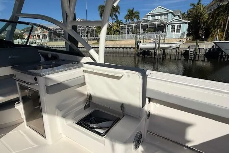 Slide: The Image of 2021 Robalo R317 Dual Console boat interior with open storage, dockside view. - 4