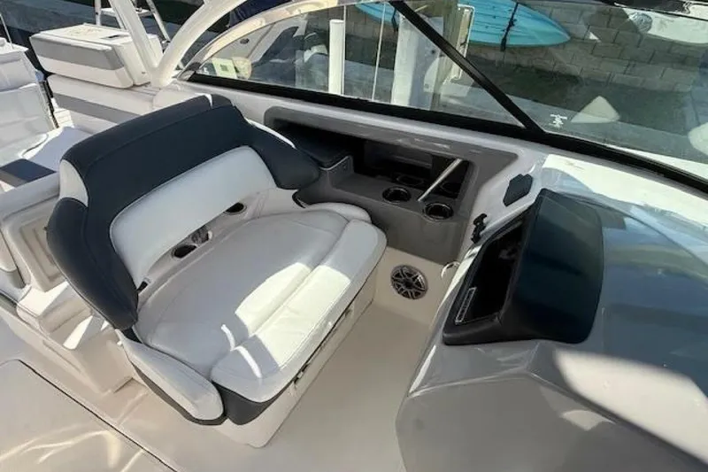 Slide: The Image of 2021 Robalo R317 Dual Console boat interior with cushioned seating and cup holders. - 5