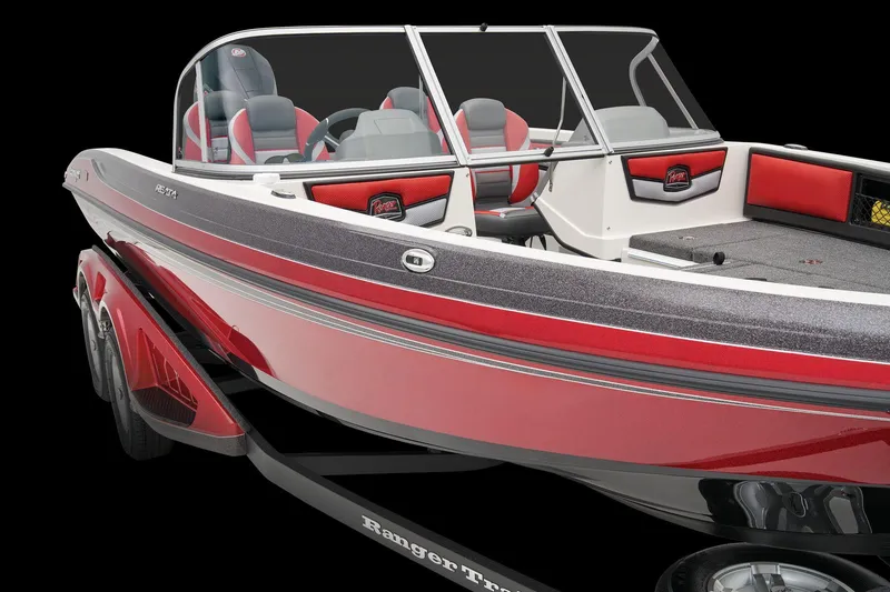 Slide: The Image of 2026 Ranger 1850MS boat interior with Minn Kota trolling motor, parked near a building. - 16