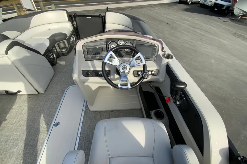 Slide: The Image of 2021 Avalon LSZ Quad Lounger boat interior with steering wheel and seating. - 14
