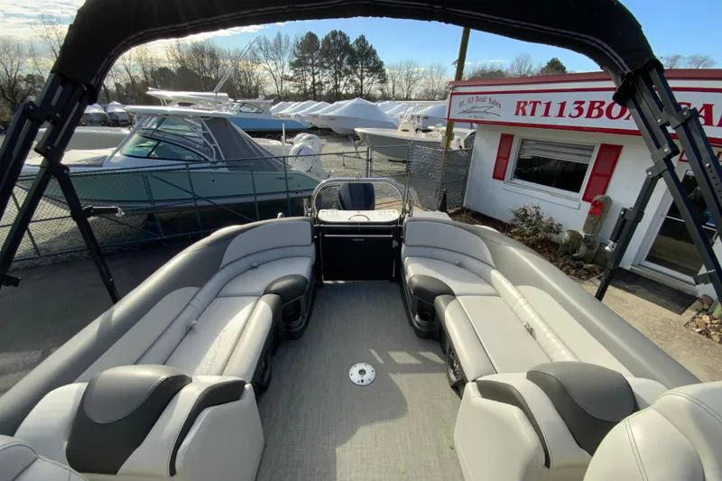 Slide: The Image of 2021 Avalon LSZ Quad Lounger boat interior with spacious seating at a boat dealership. - 17