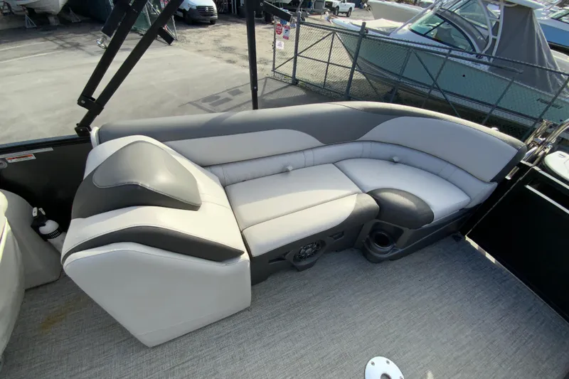 Slide: The Image of 2021 Avalon LSZ Quad Lounger boat interior with gray and black seating. - 18