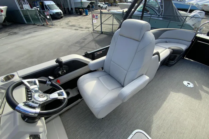 Slide: The Image of 2021 Avalon LSZ Quad Lounger boat interior with steering wheel and plush seating. - 20