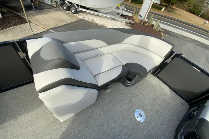 Slide: The Image of 2021 Avalon LSZ Quad Lounger boat interior with plush seating and cup holders. - 22