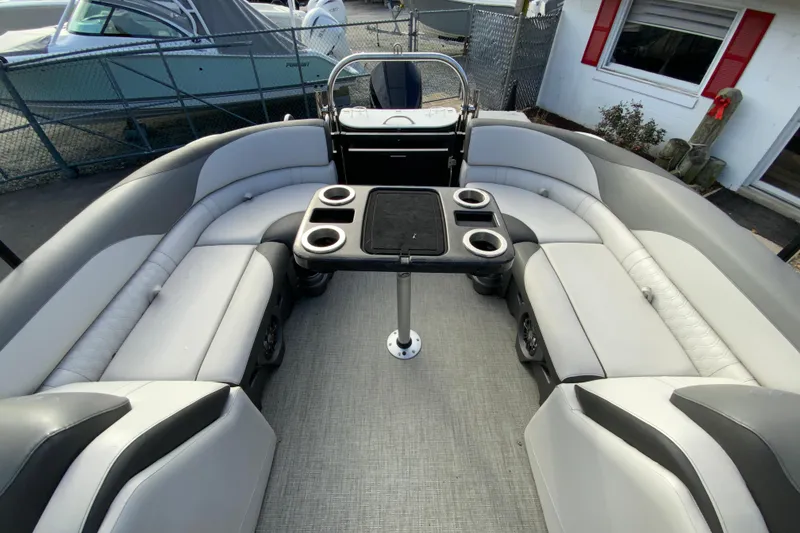 Slide: The Image of 2021 Avalon LSZ Quad Lounger boat interior with gray seating and cup holders. - 28