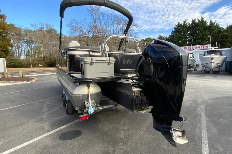 Slide: The Image of 2021 Avalon LSZ Quad Lounger 24' pontoon boat with powerful outboard motor. - 8