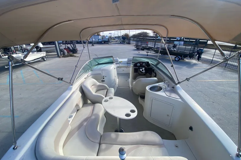 Slide: The Image of 2007 NauticStar 230DC Sport Deck boat interior with seating, table, and canopy. - 11