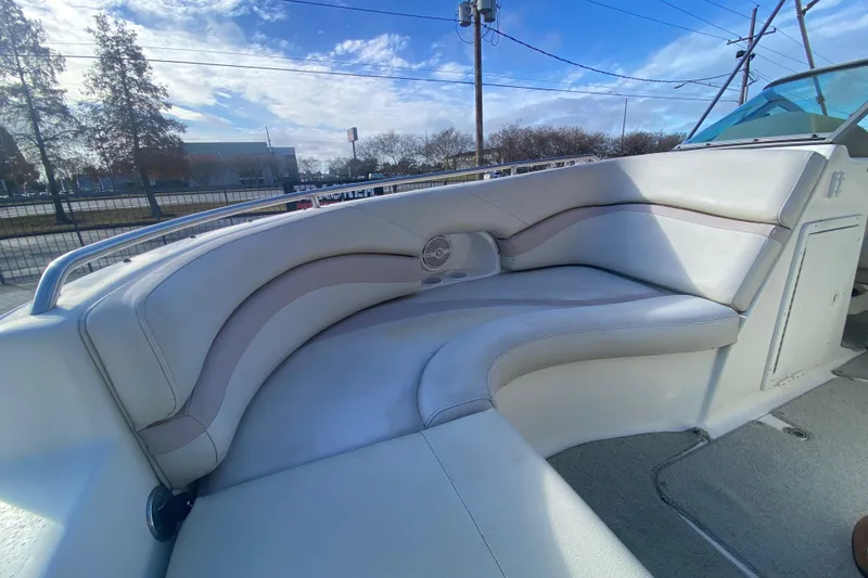 Slide: The Image of 2007 NauticStar 230DC Sport Deck boat interior with cushioned seating and cup holders. - 13