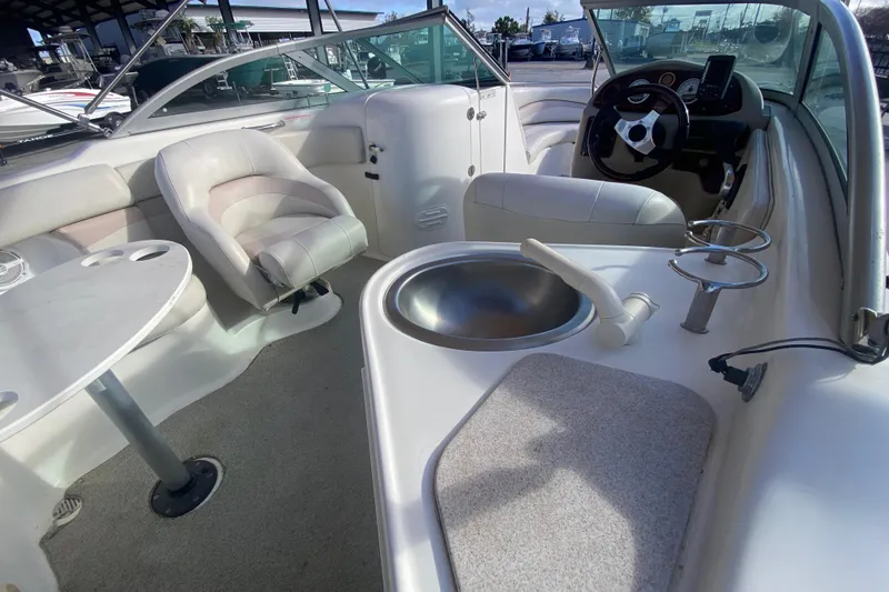 Slide: The Image of 2007 NauticStar 230DC Sport Deck interior with seating, sink, and steering console. - 15