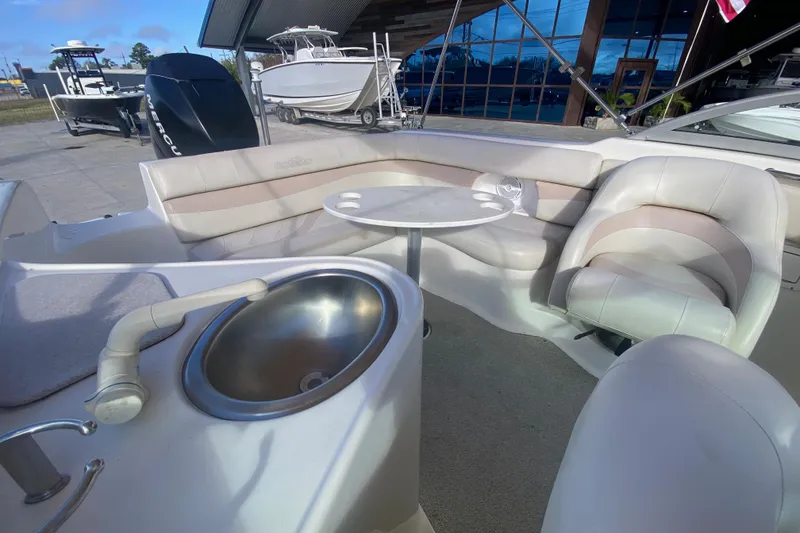 Slide: The Image of 2007 NauticStar 230DC Sport Deck interior with seating, table, and sink. - 17