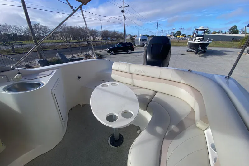 Slide: The Image of 2007 NauticStar 230DC Sport Deck boat interior with seating and table. - 18