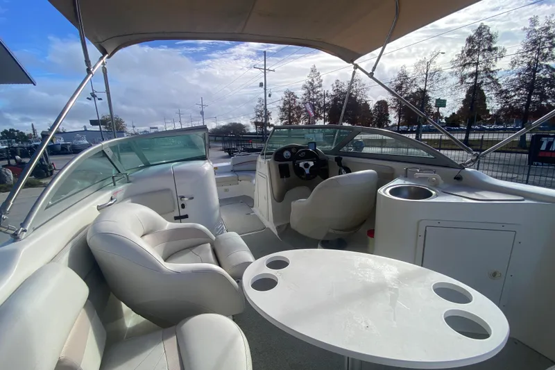 Slide: The Image of 2007 NauticStar 230DC Sport Deck boat interior with seating, table, and helm. - 19