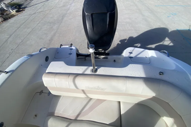Slide: The Image of 2007 NauticStar 230DC Sport Deck boat interior with seating and motor. - 20