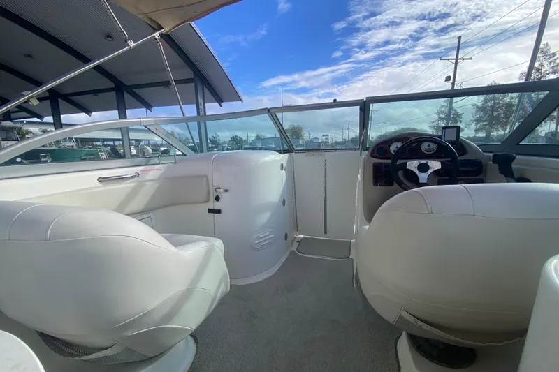 Slide: The Image of 2007 NauticStar 230DC Sport Deck interior with white seating and steering console. - 21