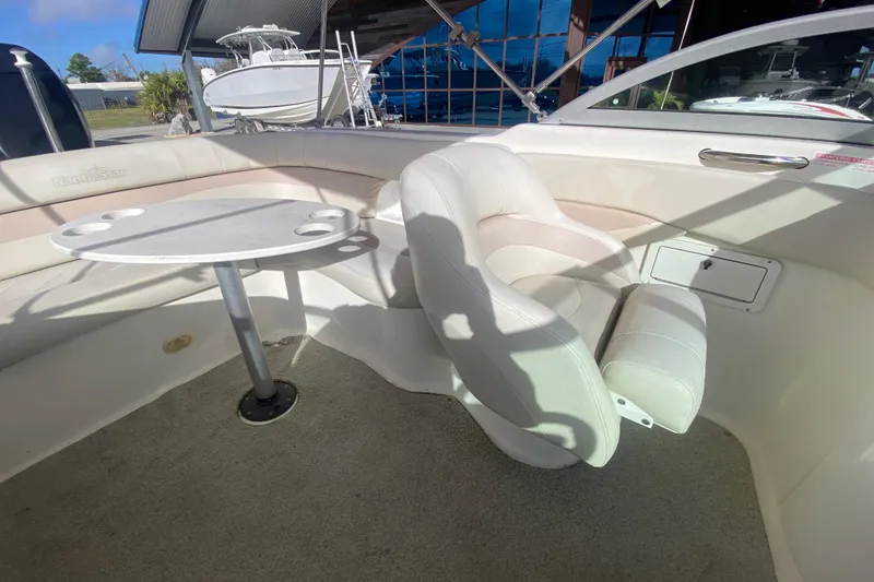 Slide: The Image of 2007 NauticStar 230DC Sport Deck interior with seating and table setup. - 22
