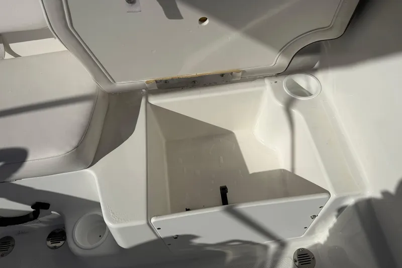 Slide: The Image of 2023 Tahoe T18 boat storage compartment with cup holders and seating area. - 15