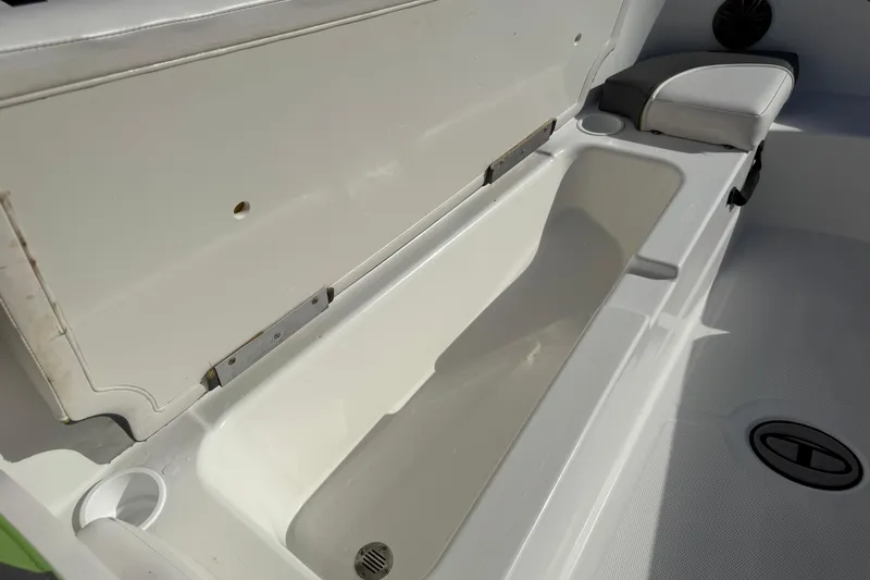 Slide: The Image of 2023 Tahoe T18 boat storage compartment with open lid, showcasing spacious interior. - 21