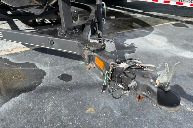 Slide: The Image of Trailer hitch of a 2023 Tahoe T18 on a wet pavement. - 28