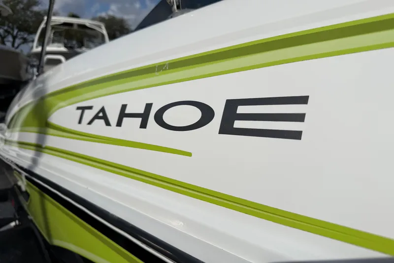 Slide: The Image of 2023 Tahoe T18 boat with green accents and bold logo. - 31