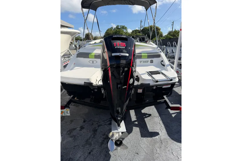 Slide: The Image of 2023 Tahoe T18 boat with Mercury 115 outboard motor, parked on a trailer. - 6