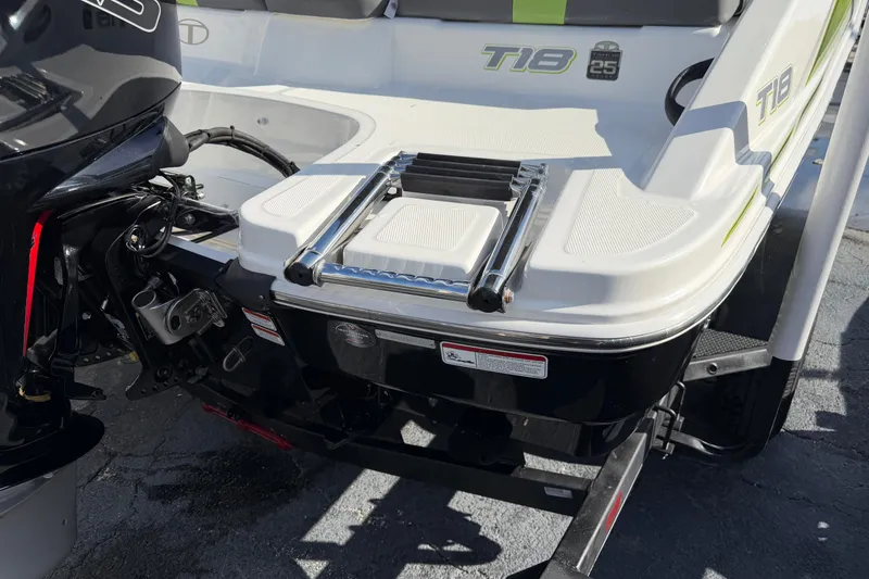 Slide: The Image of 2023 Tahoe T18 boat with ladder and motor, rear view. - 8
