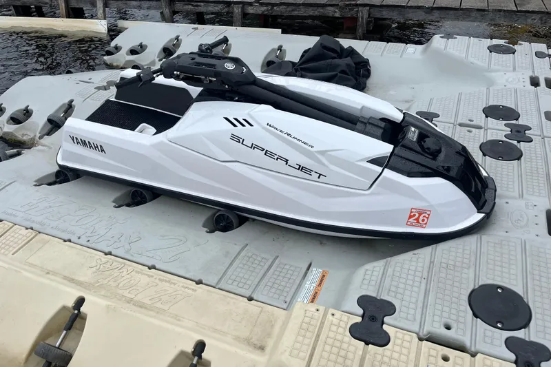 Slide: The Image of 2025 Yamaha WaveRunner SuperJet on floating dock, sleek white design. - 3