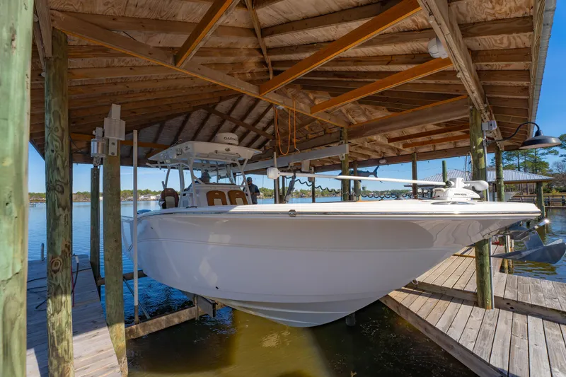 Slide: The Image of 2019 Sea Fox 328 Commander boat docked under wooden shelter. - 13