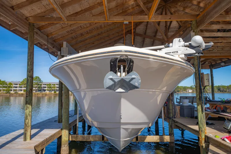 Slide: The Image of 2019 Sea Fox 328 Commander boat docked under wooden shelter. - 14