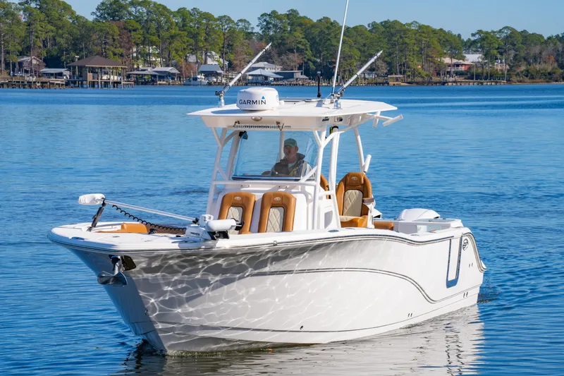 Slide: The Image of 2019 Sea Fox 328 Commander boat cruising on a calm lake with scenic background. - 2