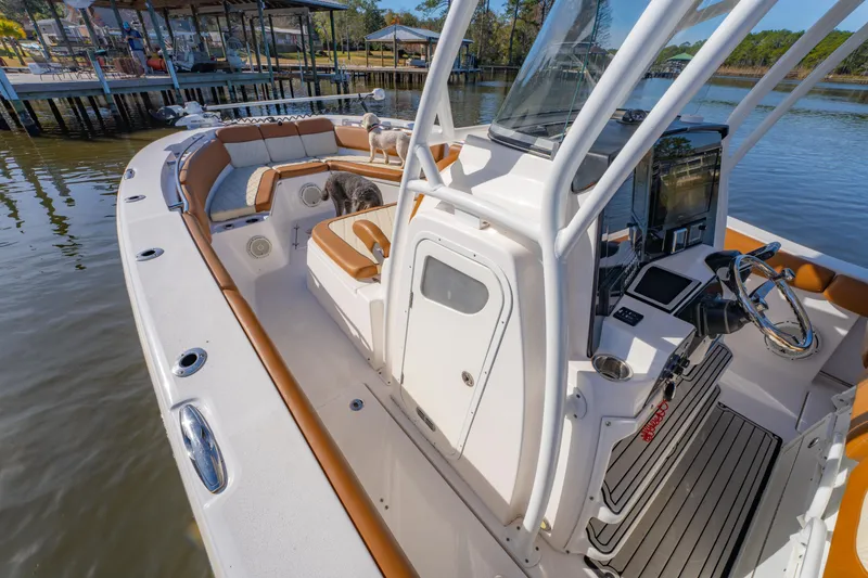 Slide: The Image of 2019 Sea Fox 328 Commander boat interior with helm, seating, and dogs on deck. - 22