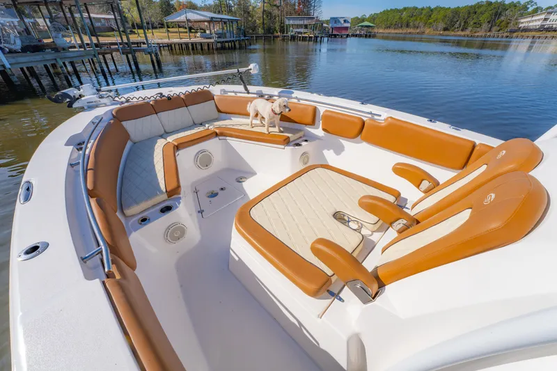 Slide: The Image of 2019 Sea Fox 328 Commander boat interior with tan seating and a small dog. - 23