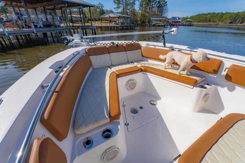 Slide: The Image of 2019 Sea Fox 328 Commander boat interior with dog on deck, near waterfront homes. - 24