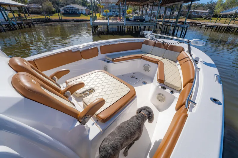 Slide: The Image of 2019 Sea Fox 328 Commander boat interior with tan seating and a dog on deck. - 25