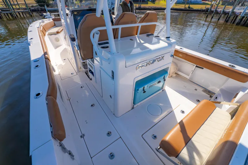 Slide: The Image of 2019 Sea Fox 328 Commander boat interior with tan seating and white deck. - 30