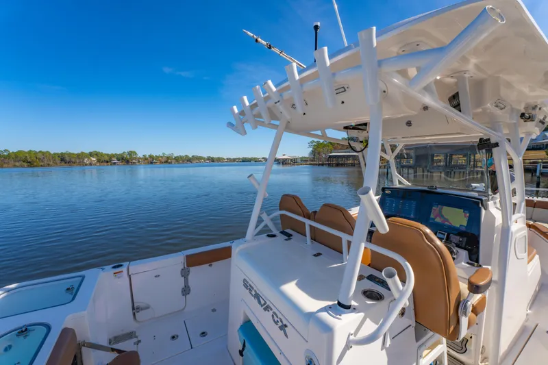 Slide: The Image of 2019 Sea Fox 328 Commander boat on calm water, featuring modern helm and seating. - 32