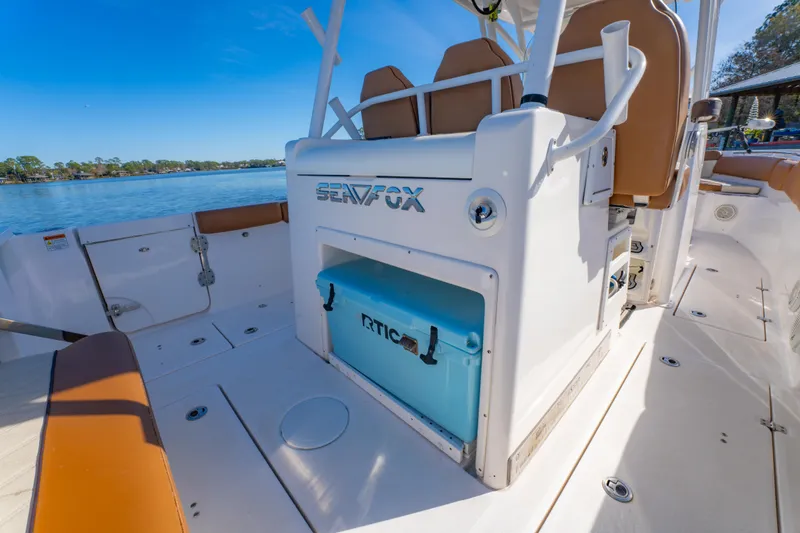 Slide: The Image of 2019 Sea Fox 328 Commander boat interior with RTIC cooler, on a sunny day by the water. - 33
