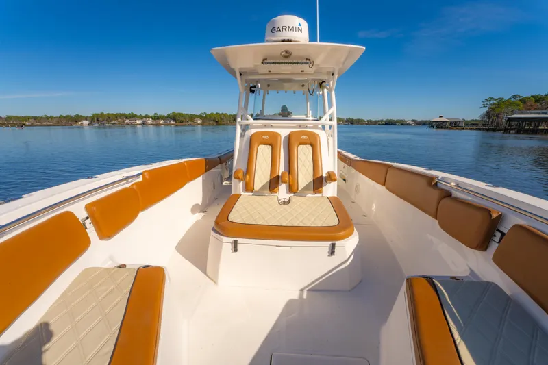 Slide: The Image of 2019 Sea Fox 328 Commander boat interior with tan seating on a calm lake. - 35