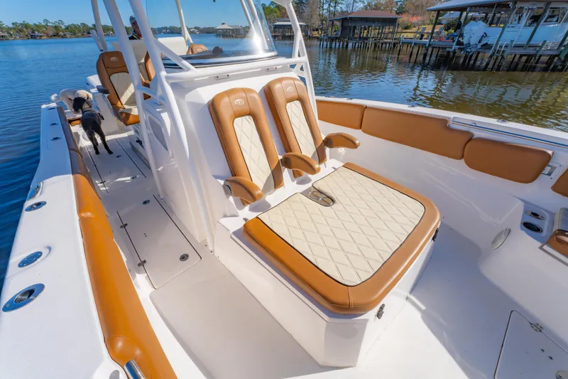 Slide: The Image of 2019 Sea Fox 328 Commander boat interior with tan seating, docked by calm waters. - 36