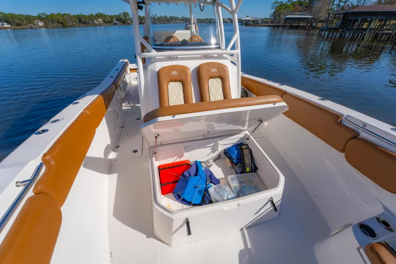Slide: The Image of 2019 Sea Fox 328 Commander boat interior with open storage compartment on a calm lake. - 38