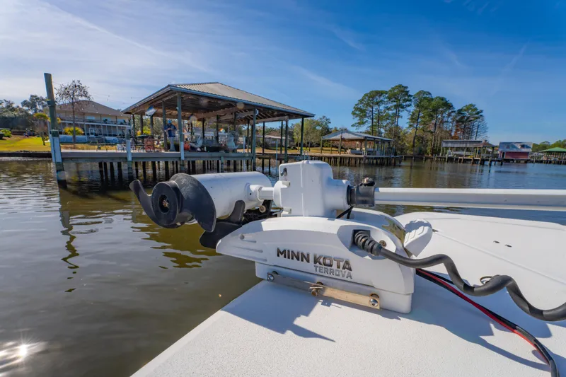 Slide: The Image of 2019 Sea Fox 328 Commander with Minn Kota Terrova motor near a dockside pavilion. - 49