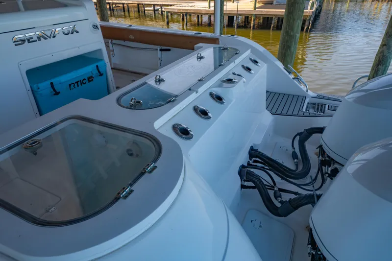 Slide: The Image of 2019 Sea Fox 328 Commander boat interior with fishing rod holders and RTIC cooler. - 52