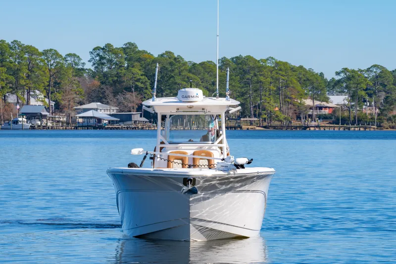 Slide: The Image of 2019 Sea Fox 328 Commander boat on calm water with scenic shoreline background. - 8