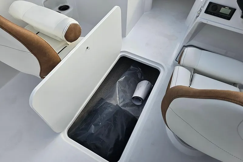 Slide: The Image of 2026 Stingray 191 DC boat interior with white and brown seating and floor hatch. - 13