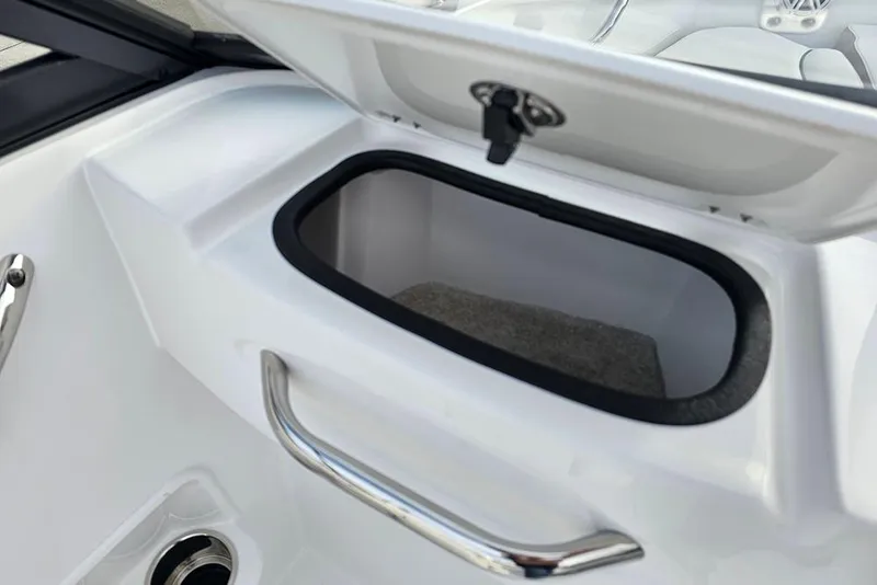 Slide: The Image of 2026 Stingray 191 DC boat interior with white seating, cup holders, and sleek design. - 15