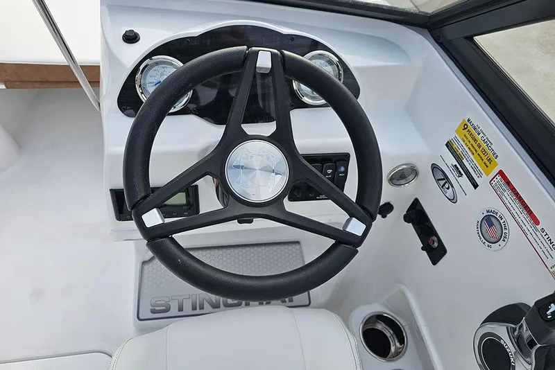 Slide: The Image of 2026 Stingray 191 DC boat capacity label, 9 persons or 1237 lbs, safety compliance. - 17