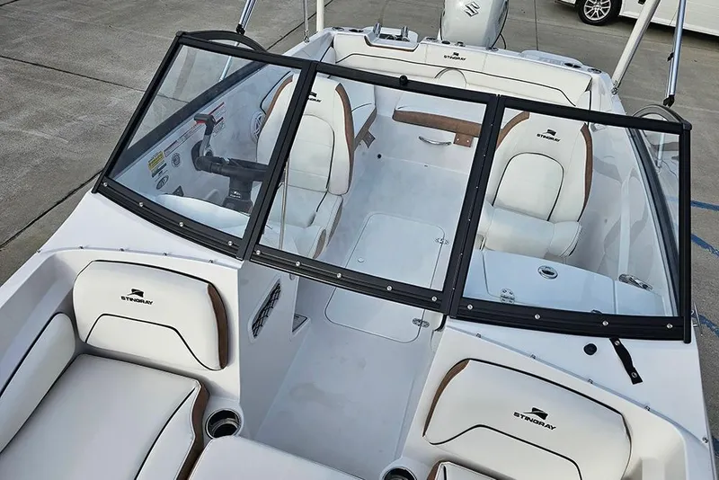 Slide: The Image of 2026 Stingray 191 DC boat interior with white seating and sleek design. - 19