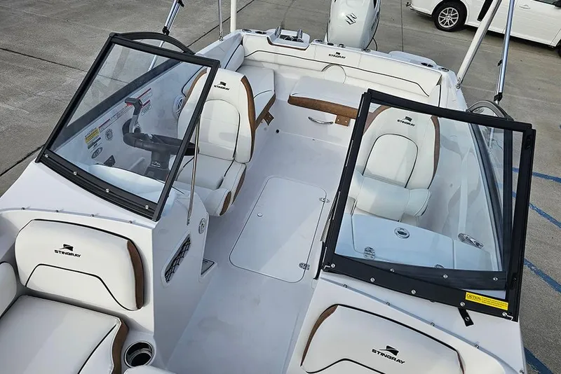 Slide: The Image of 2026 Stingray 191 DC boat interior with white seating and dual consoles. - 20