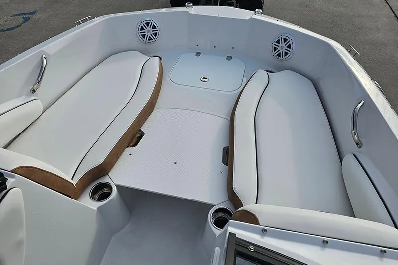 Slide: The Image of 2026 Stingray 191 DC boat interior with white cushioned seating and cup holders. - 21